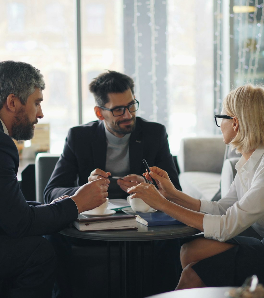 Business professionals in conversation in a bright office